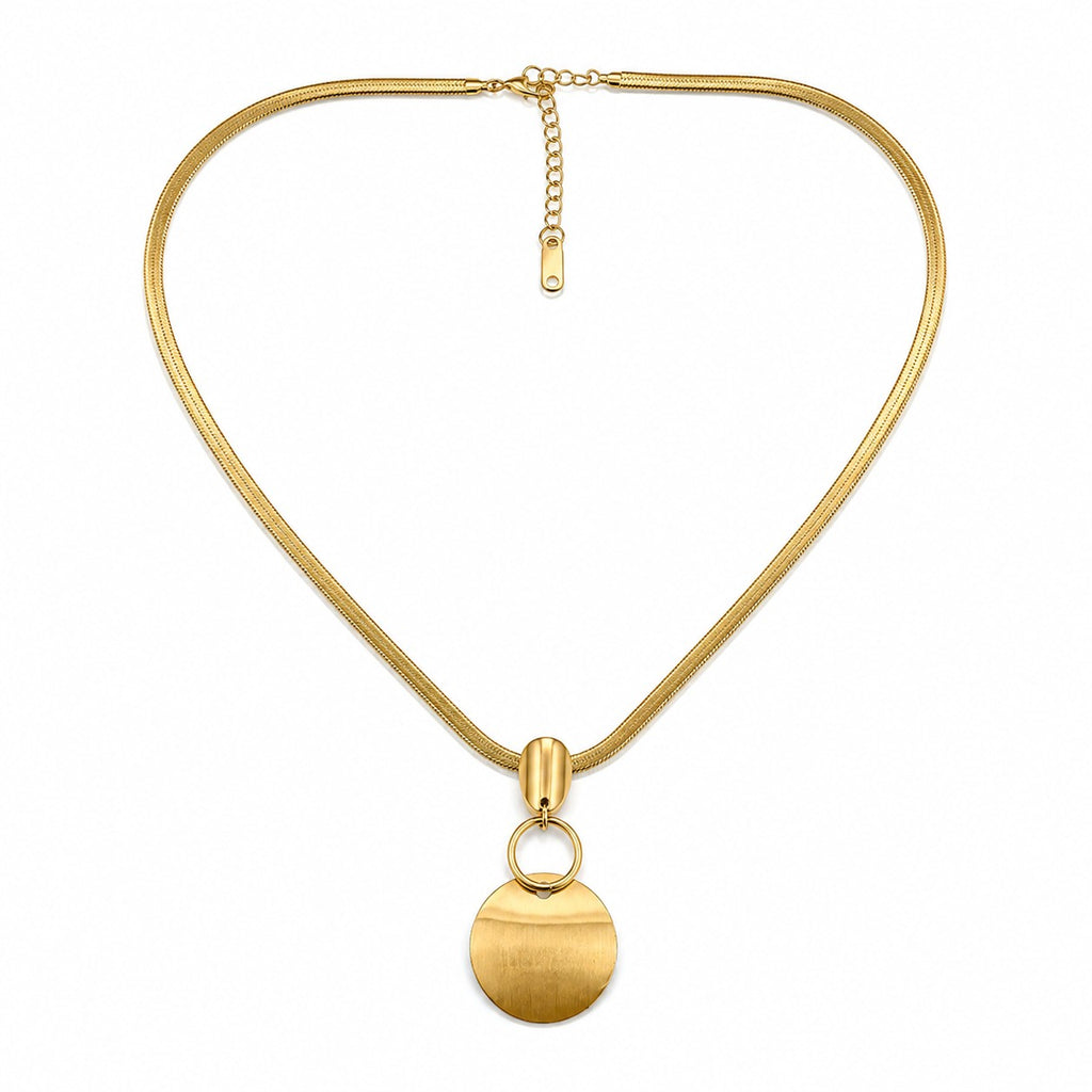 Gold-tone disc pendant snake chain necklace styled with a white blouse