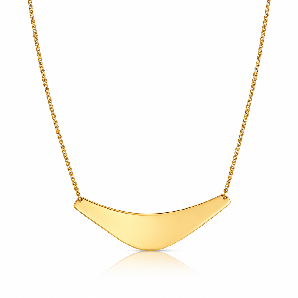 Gold-tone curved crescent pendant necklace on a fine link chain against white