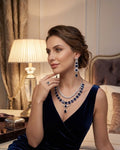 Exquisite Pear-Cut Earrings: Includes a bold pair of statement earrings featuring an intricate pear-shaped drop design for a regal finish.