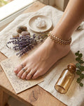 Gold floral pearl anklet and toe rings styled with lavender and natural elements