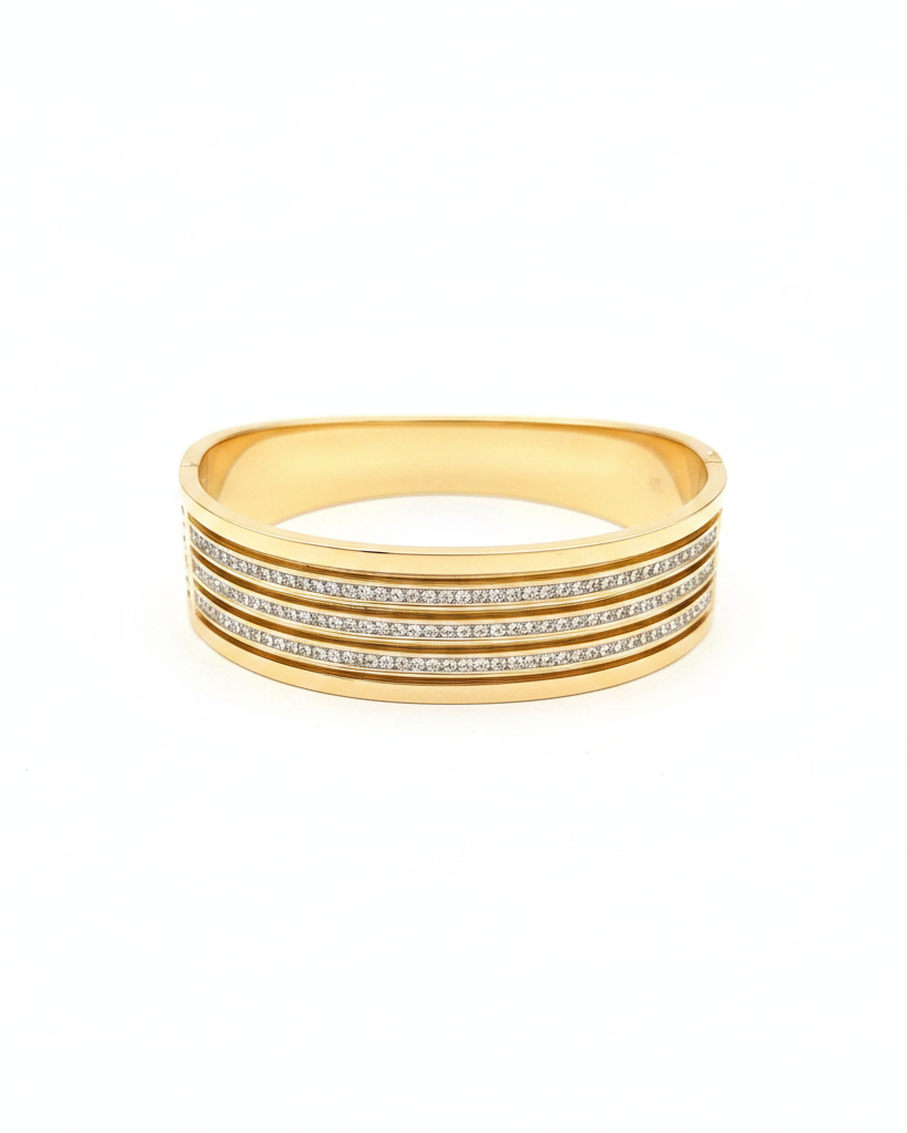 Gold triple row pavé diamond wide cuff bangle on white background