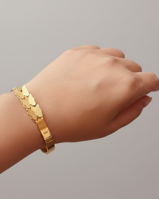 Gold scale texture bangle bracelet lifestyle shot worn on wrist