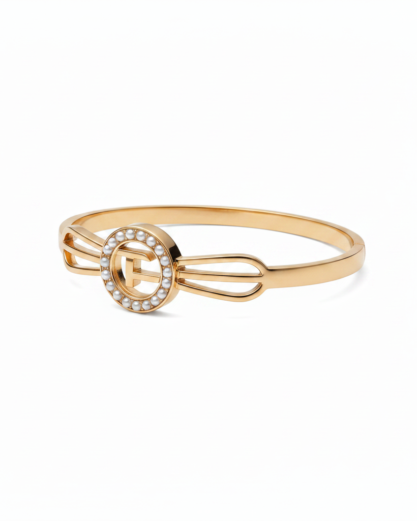 Gold medallion bow bangle on white background studio shot