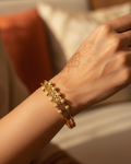 Gold geometric bangle bracelet lifestyle shot worn on wrist