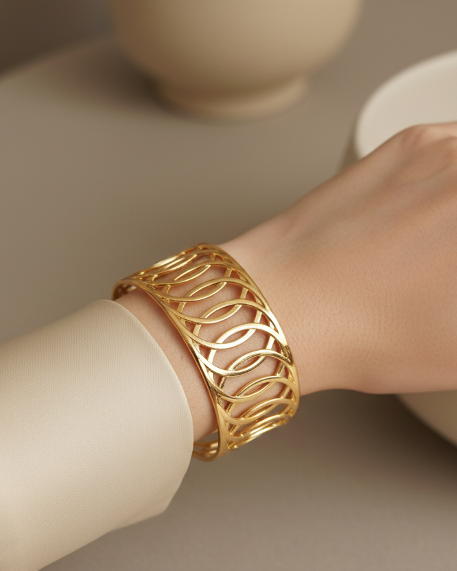 Model wearing gold interlocking circles openwork cuff bracelet
