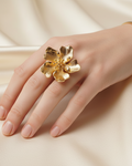 Gold flower ring lifestyle image - worn on hand