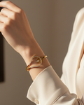 Model wearing gold diamond wave cuff bracelet