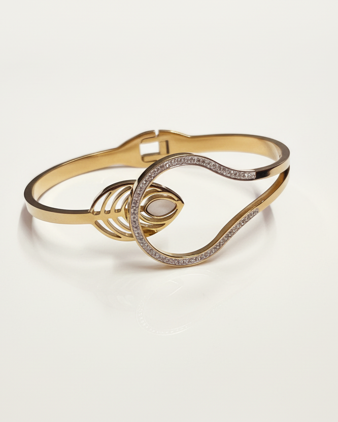 Gold diamond wave cuff bracelet on white background