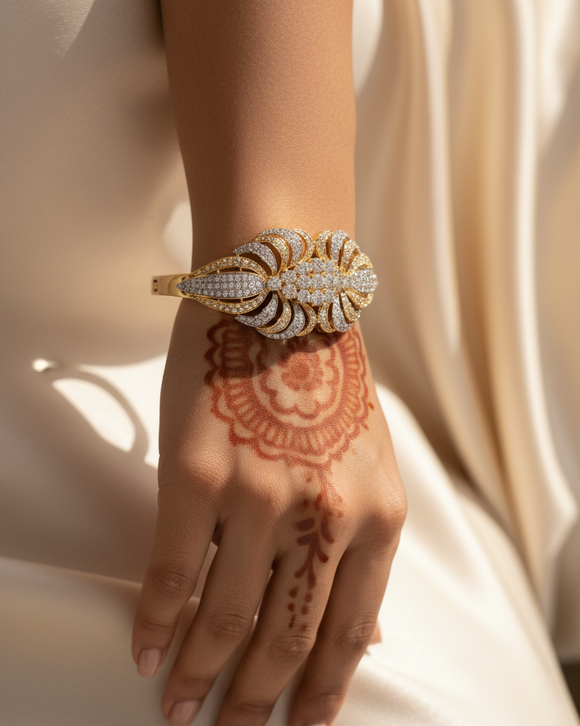 Gold diamond pavé butterfly wing bangle lifestyle shot worn on wrist