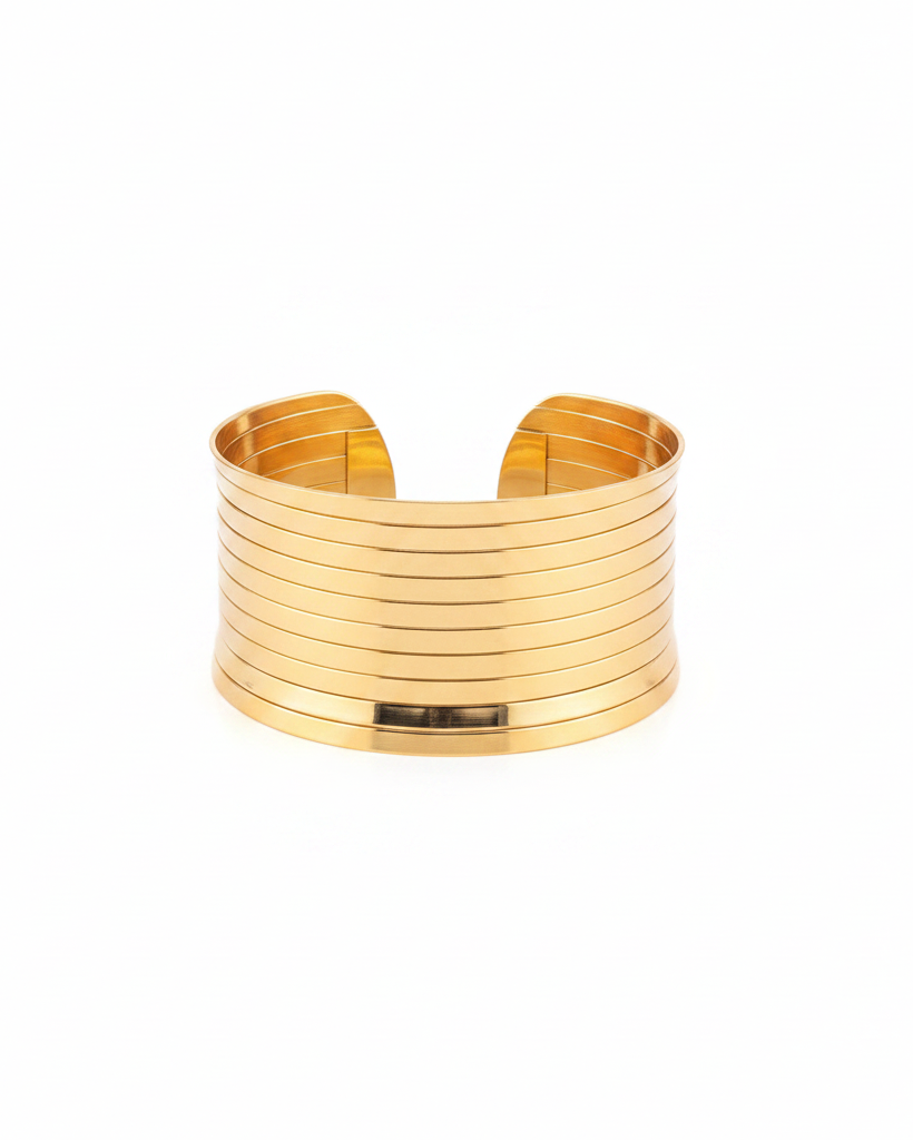 Gold multi-row stacked wide cuff bangle on white background
