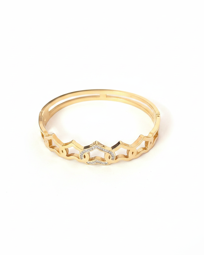 Gold crown scallop bangle bracelet on white background studio shot