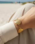 Model wearing gold seashell cuff bracelet
